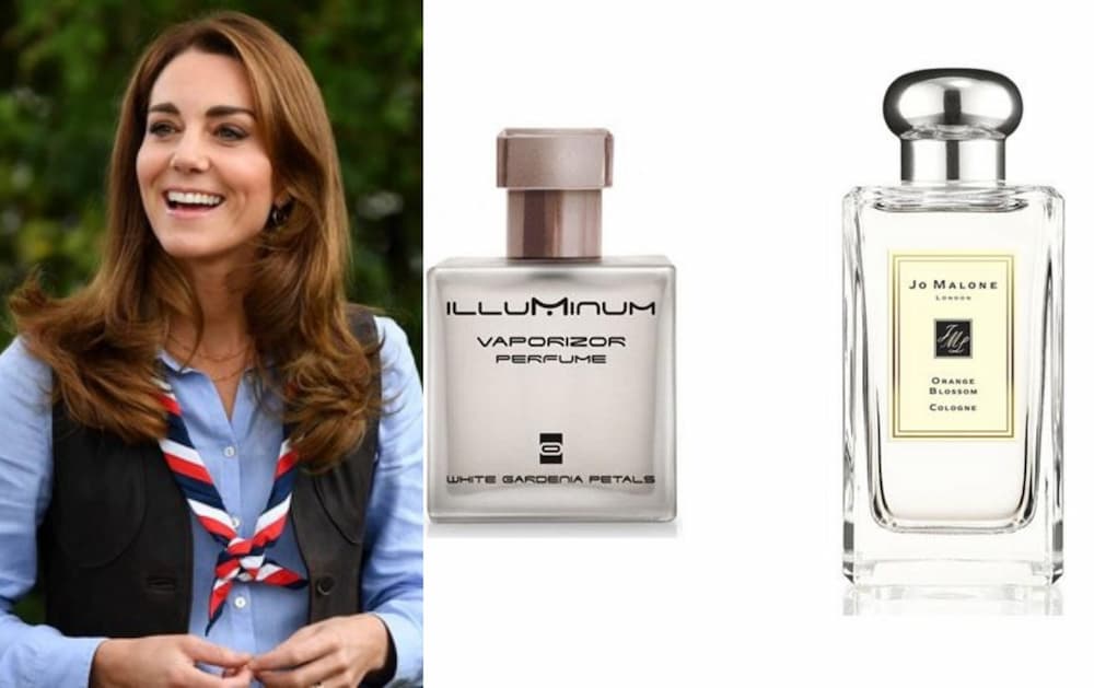 a woman smiling next to a bottle of perfume